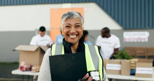 A woman with a clipboard, managing volunteers