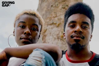 Giving Gap logo and two people