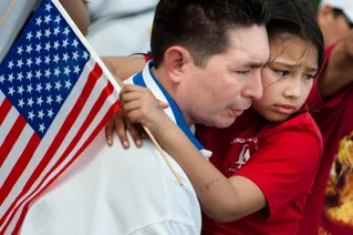 little girl with dad holding american flag