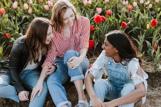 Women sitting in flowers